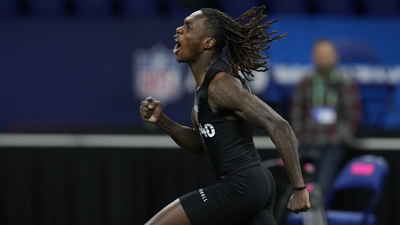 Texas wide receiver Xavier Worthy celebrates after running the 40-yard dash at the NFL football scouting combine, Saturday, March 2, 2024, in Indianapolis. (AP Photo/Darron Cummings)