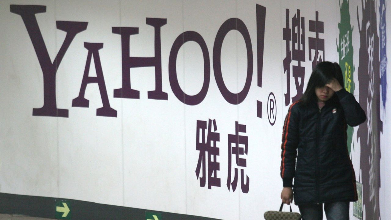 A woman walks past a Yahoo billboard in a Beijing subway.  (AP Photo, File)