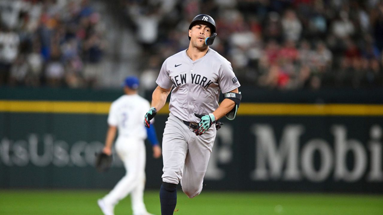 New York Yankees' Giancarlo Stanton runs the bases after hitting a solo home run in the eighth inning of a baseball game against the Texas Rangers, Monday, Sept. 2, 2024, in Arlington, Texas. (AP Photo/Albert Pena)