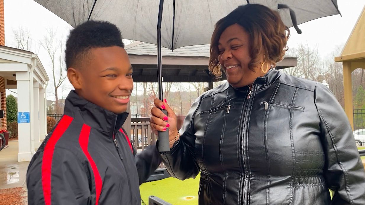 Zaneta and her son Nathan walk outside. 