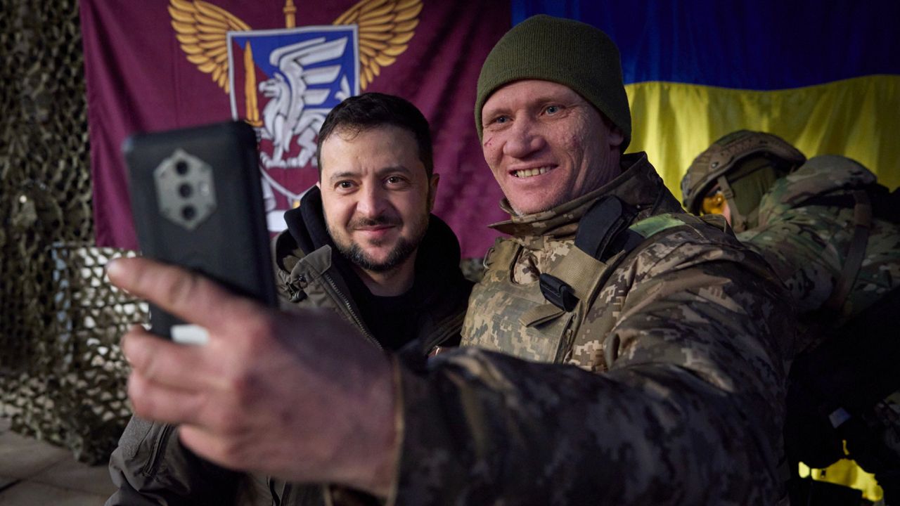 A Ukrainian soldier takes a selfie with President Volodymyr Zelenskyy, left, during his visit to Sloviansk, Donbas region, Ukraine, Tuesday. (Ukrainian Presidential Press Office via AP)