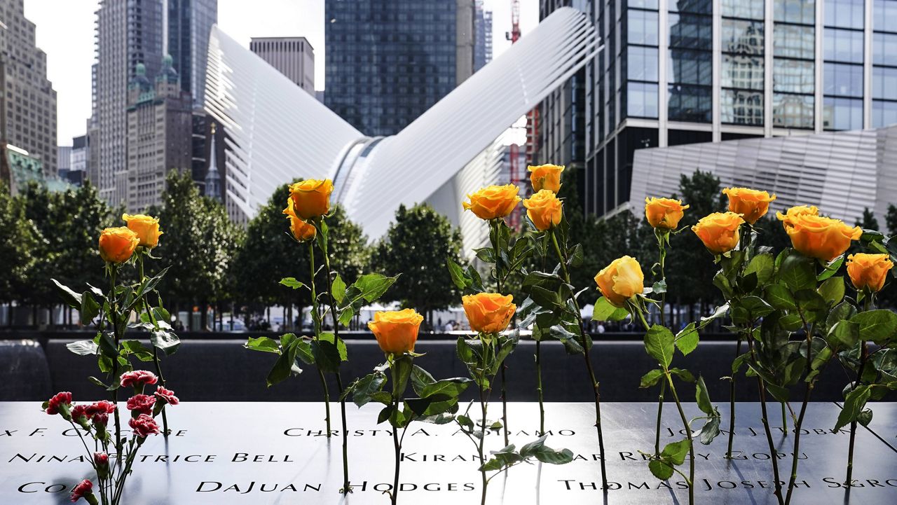 Flowers are placed in the inscribed names of the deceased at the 9/11 Memorial & Museum in New York on Sept. 11, 2020. (AP Photo/John Minchillo, File)