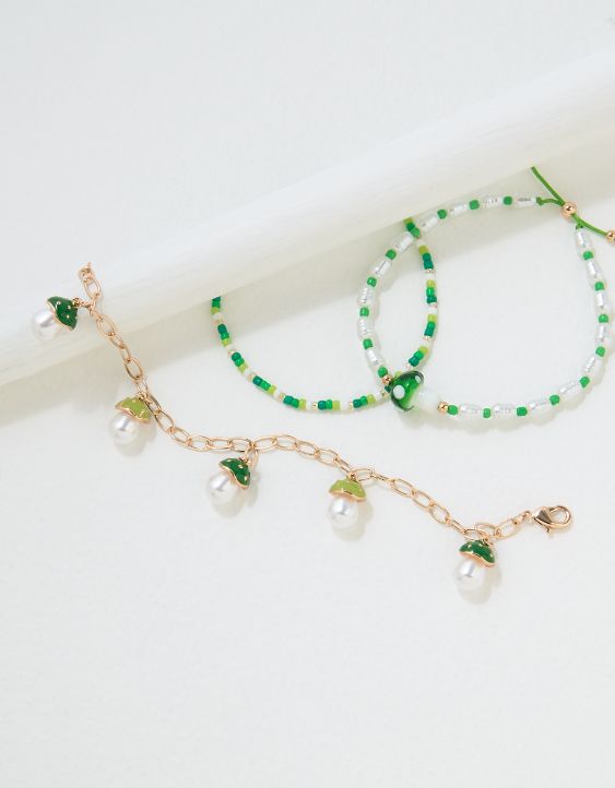 Emballage de trois bracelets à breloques champignon doré et vert AEO