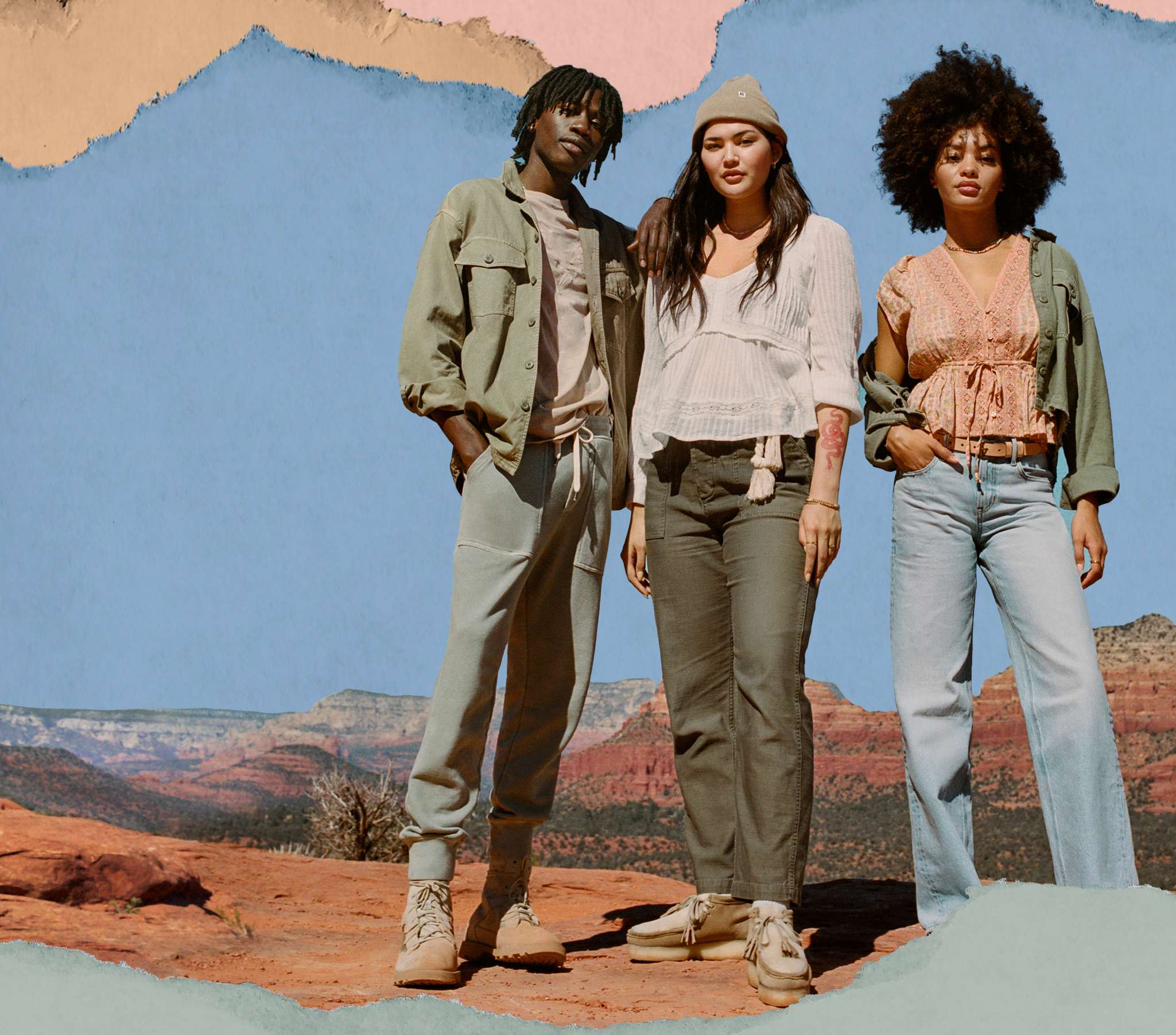 three people standing on red rocks in AE utility trend clothing