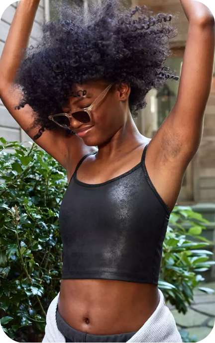 girl wearing black offline top and sunglasses with arms in the air