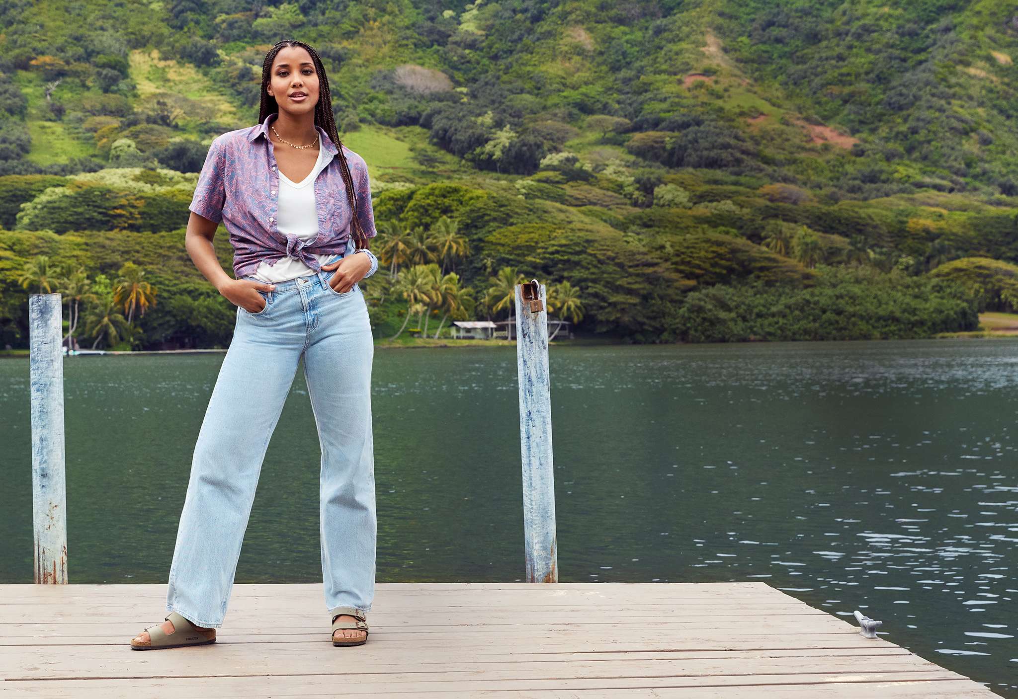woman wearing AE jeans standing on dock 