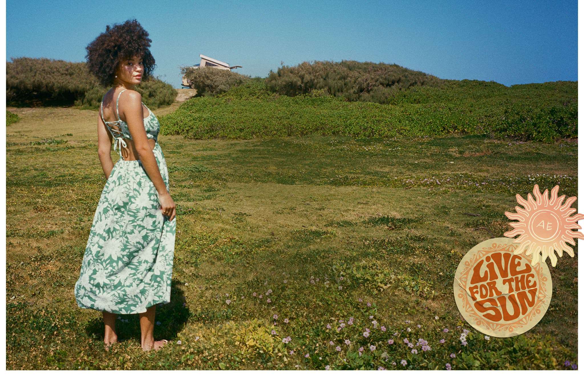 girl in a sun dress standing in a field