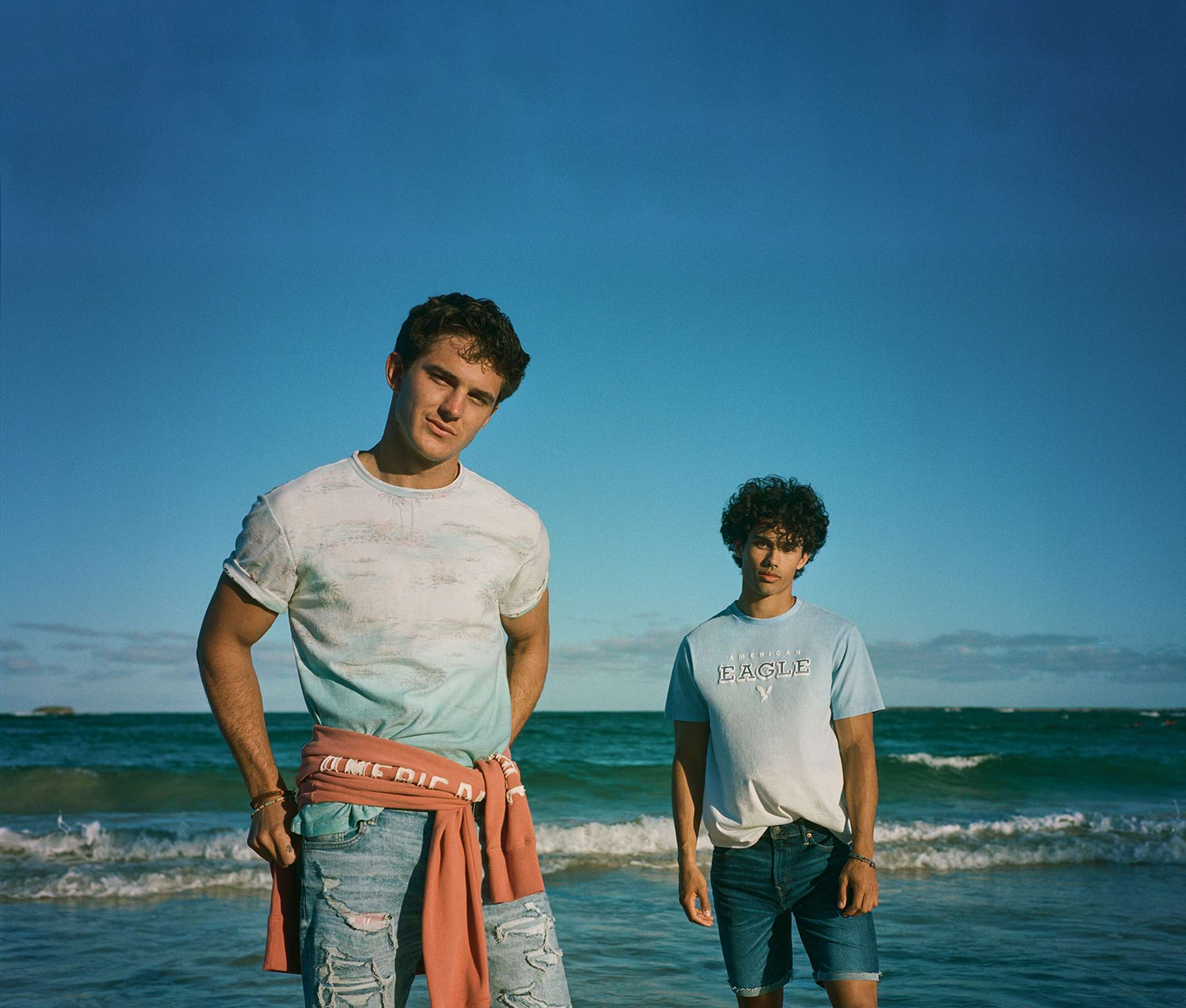 two men in AE gradient tees on the beach