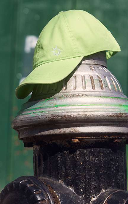 green hat on top of fire hydrant