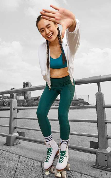model wearing leggings and roller skates on a bridge