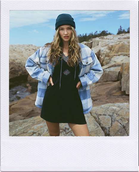 model wearing AE dress with flannel shacket standing on rocks