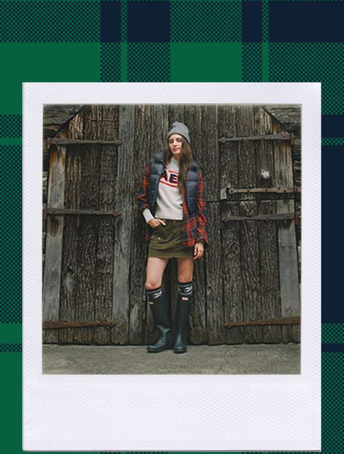 womens outfit featuring a beanie, flannel, vest, skirt, and boots