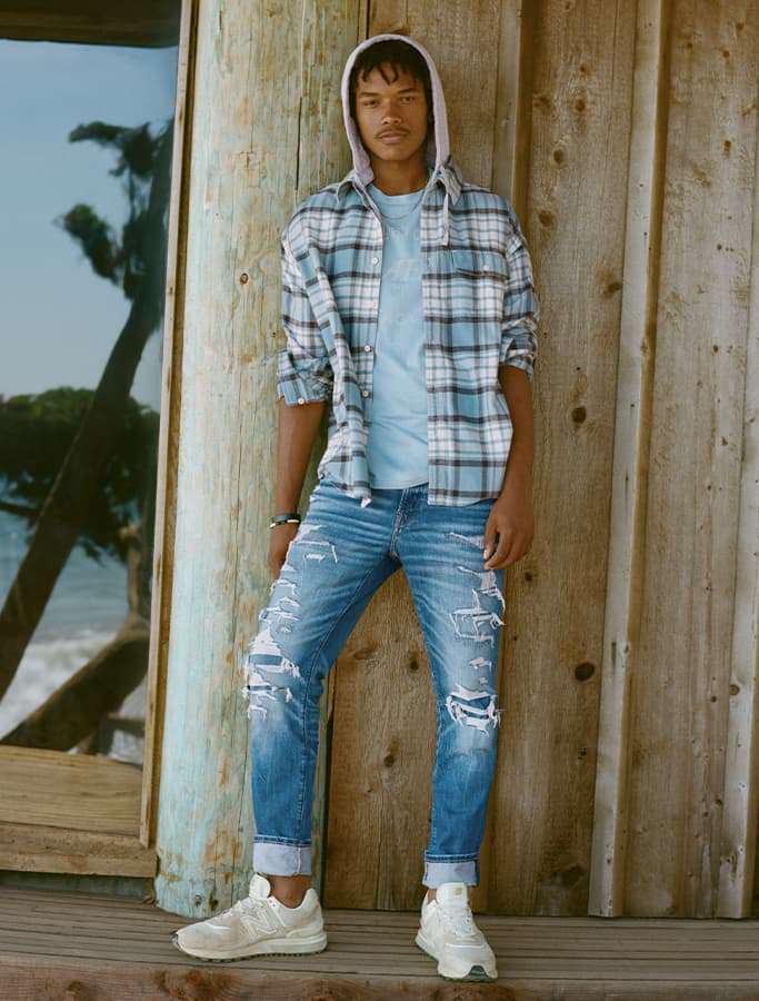 model in ripped jeans and flannel
