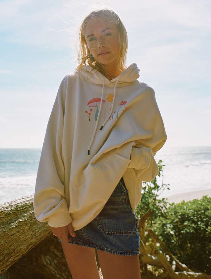 model on beach wearing hoodie