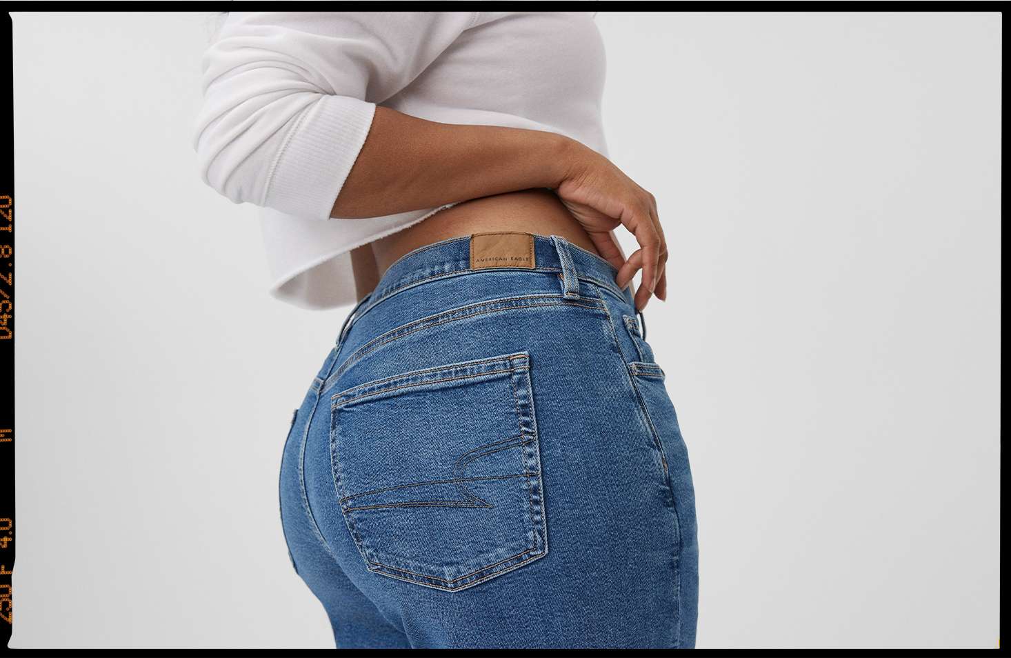 Model in AE women's high waisted straight-leg jeans