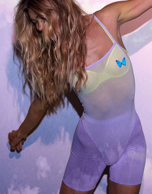 Model in SMOOTHEZ violet mesh bodysuit with yellow mesh unlined bra and violet bike short underwear underneath
