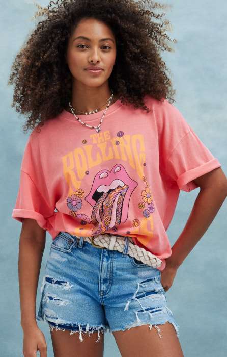 Female model wearing pink The Rolling Stones logo t-shirt
