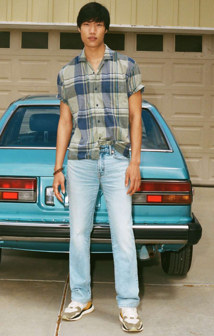 model wearing plaid shirt and jeans