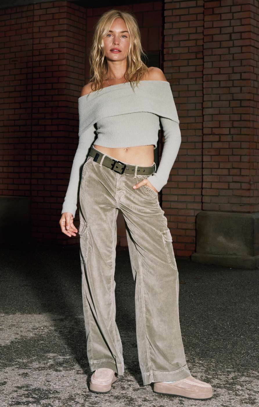 Model wearing cargo pants with belt and top