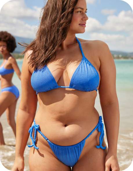 model on beach in blue bikini
