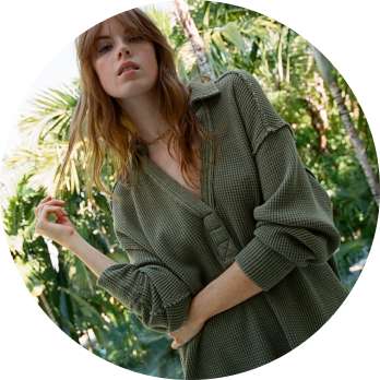 model in green button up 