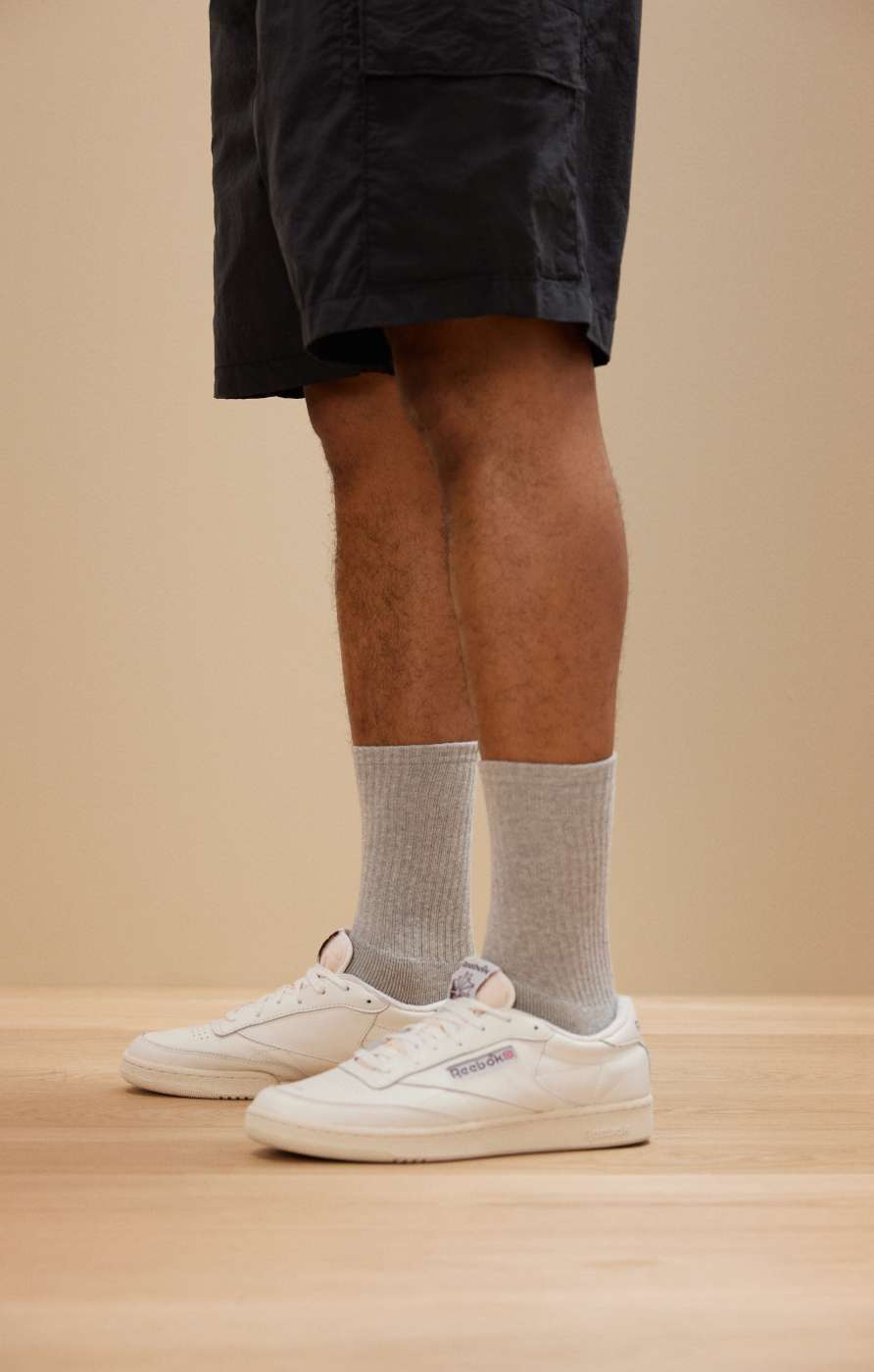 close up of model wearing grey crew socks 