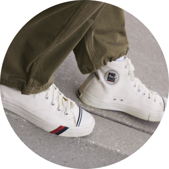 cropped image of men's white sneakers