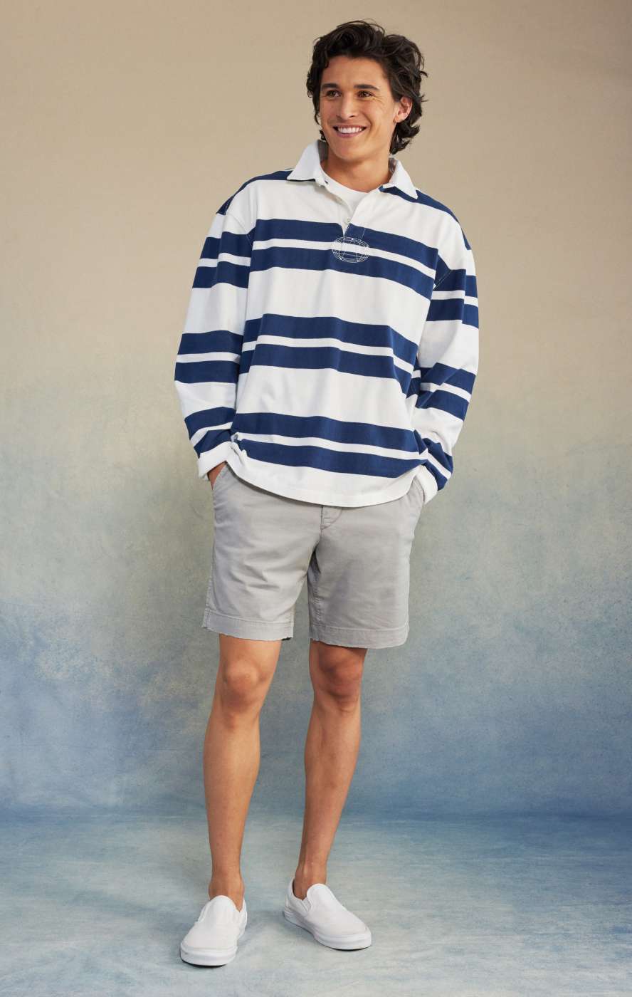 model wearing grey colored khaki shorts and striped long sleeve shirt