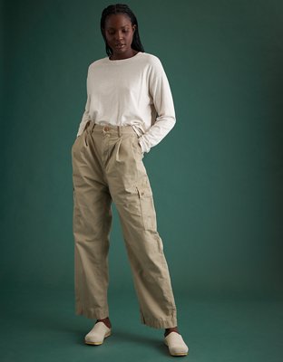 Premium Photo  A woman in a white top and cargo pants stands in