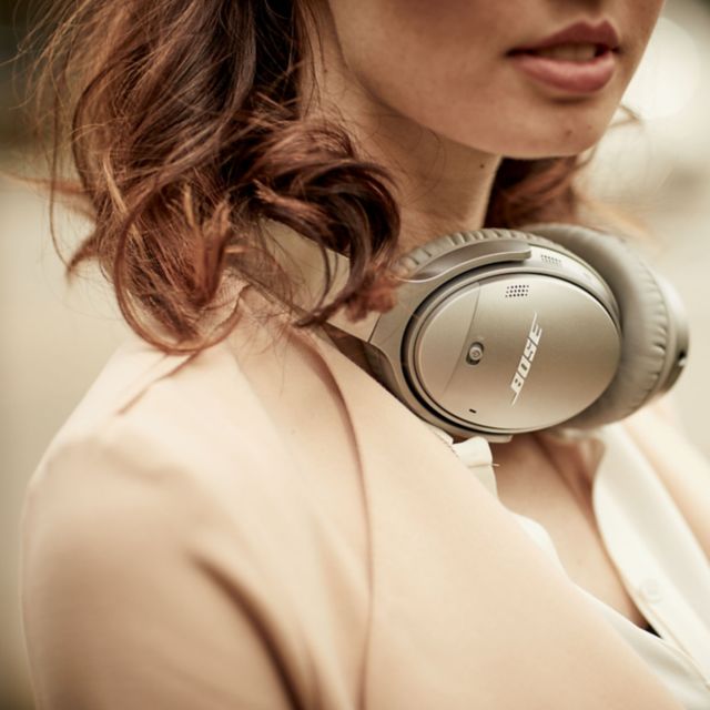 Girl having QuietComfort 35 headphones around neck