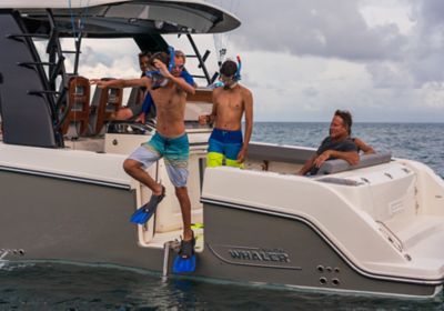 Kids jumping out of dive door with snorkle gear