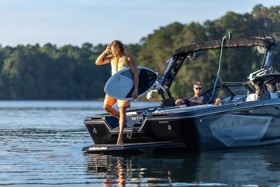 Man standing on the back of a Heyday wake boat