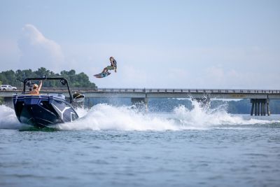 Wakeboarder up in the air behind a Heyday Wake boat