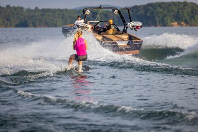 woman wakeboarding behind a Heyday wake boat