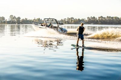 Wakeboarder riding behind Heyday Wake Boat