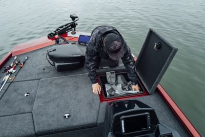 Fisherman Looking Into Storage on Lowe Stinger 175C Mod V Bass Boat