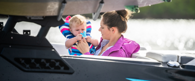 woman and a baby sitting in a Heyday boat