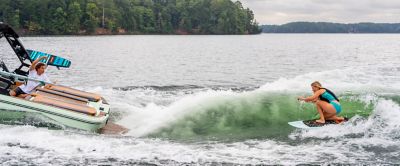 woman wakesurfing behind a Heyday boat