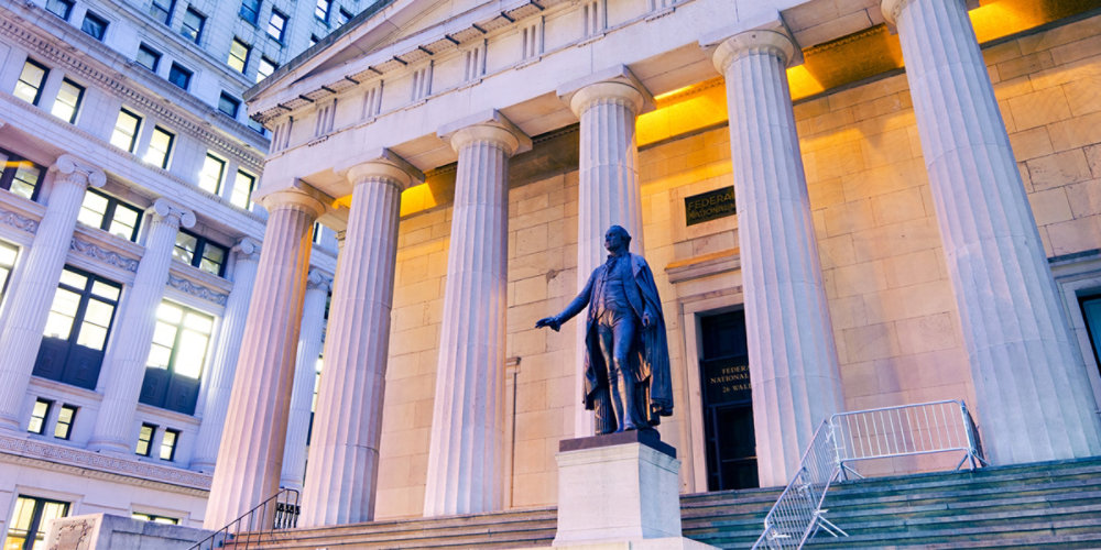 Historic city building with statue at dusk