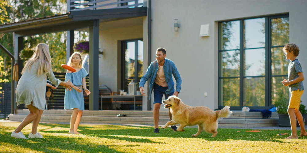 Family with dog outside home