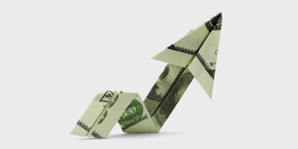 Dollar bill folded to look like an upward trending graph