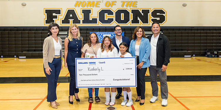 Home of the Falcons with LAUSD members holding Dollars + Sense check