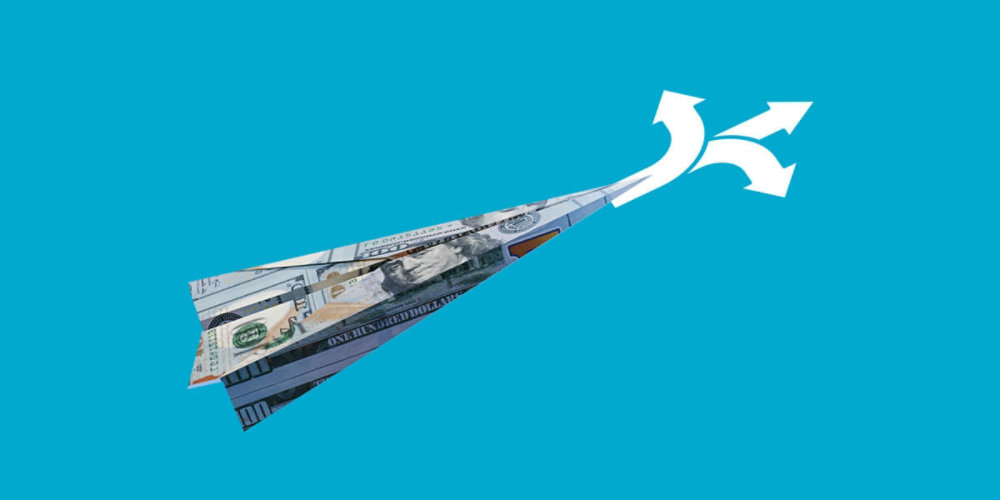 Currency folded into a paper airplane with arrows pointing in many directions