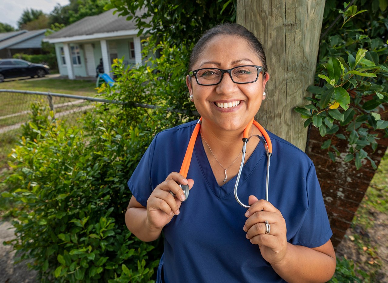 Ingrid Fernandez, a nurse, in front of her home 