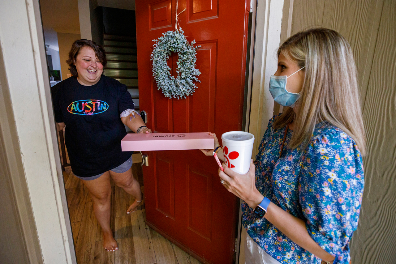 Jane Nodskov (story subject) Right visits and drops off cookies to Taylor Diercks Leukemia Left