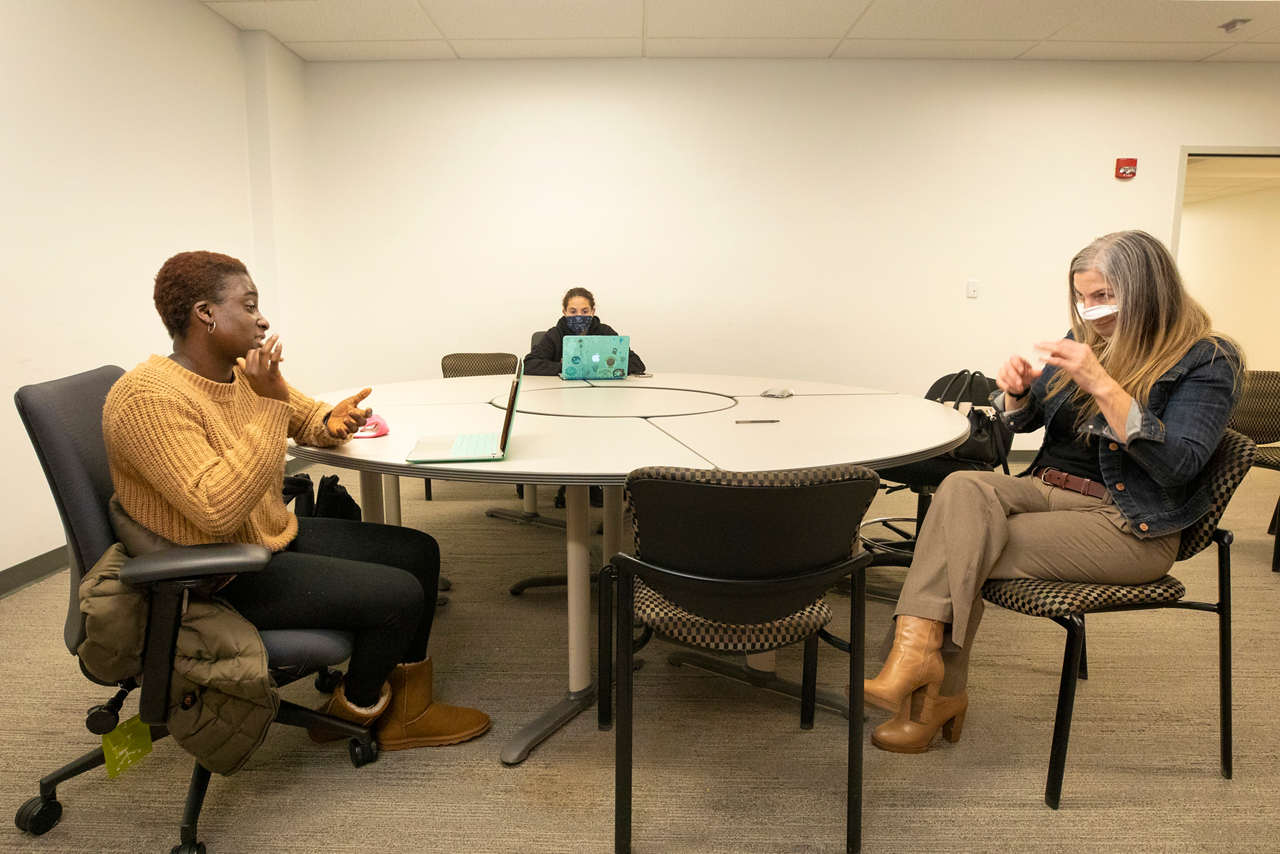 Maameyaa working at her campus job as a ASL consultant. She is working with Deirdre Kosky, a professional ASL translator at RIT.  