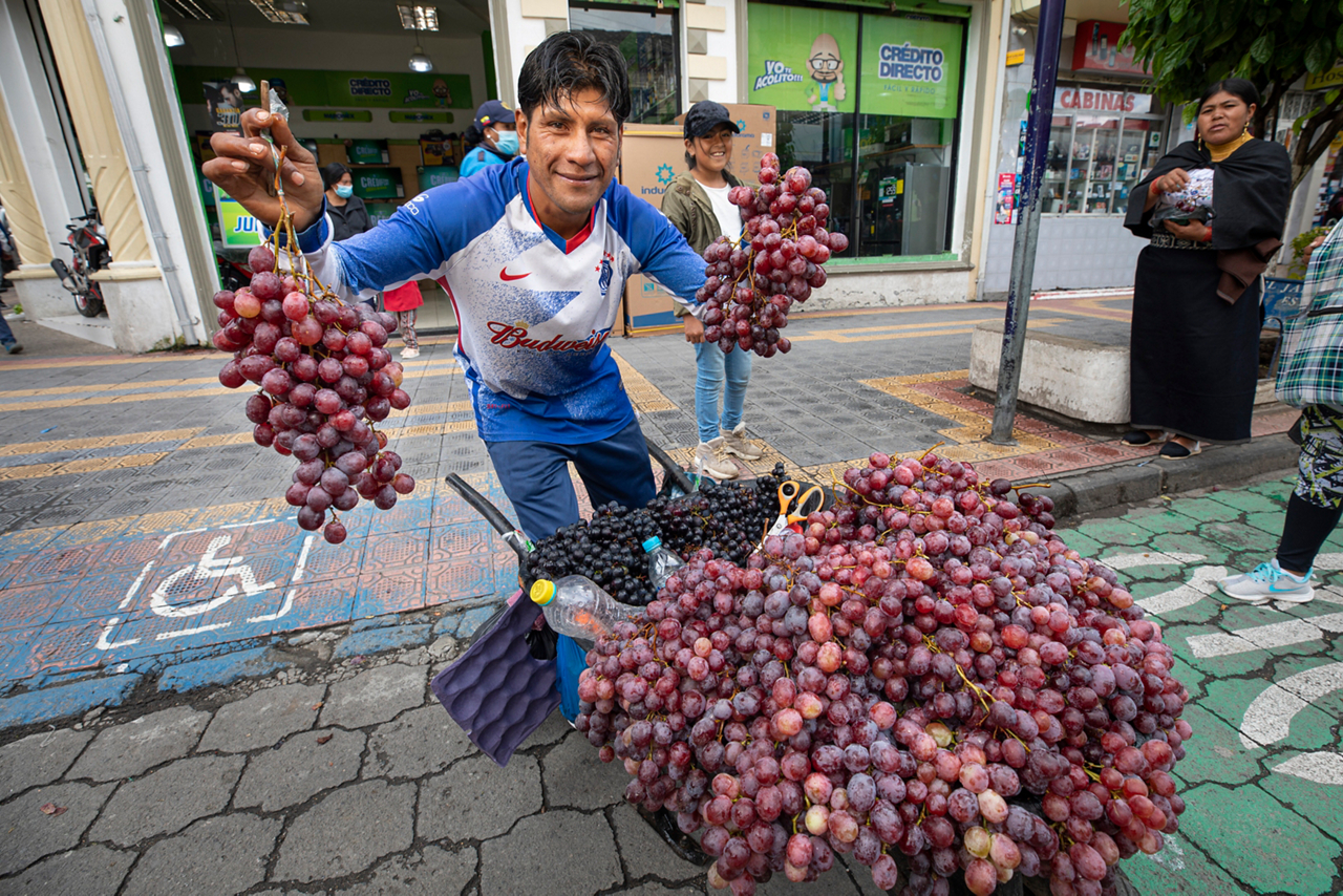 Men and women in Otavalo, a city in northern Ecuador, venture from homes in the highlands of the Andes Mountains onto city streets.