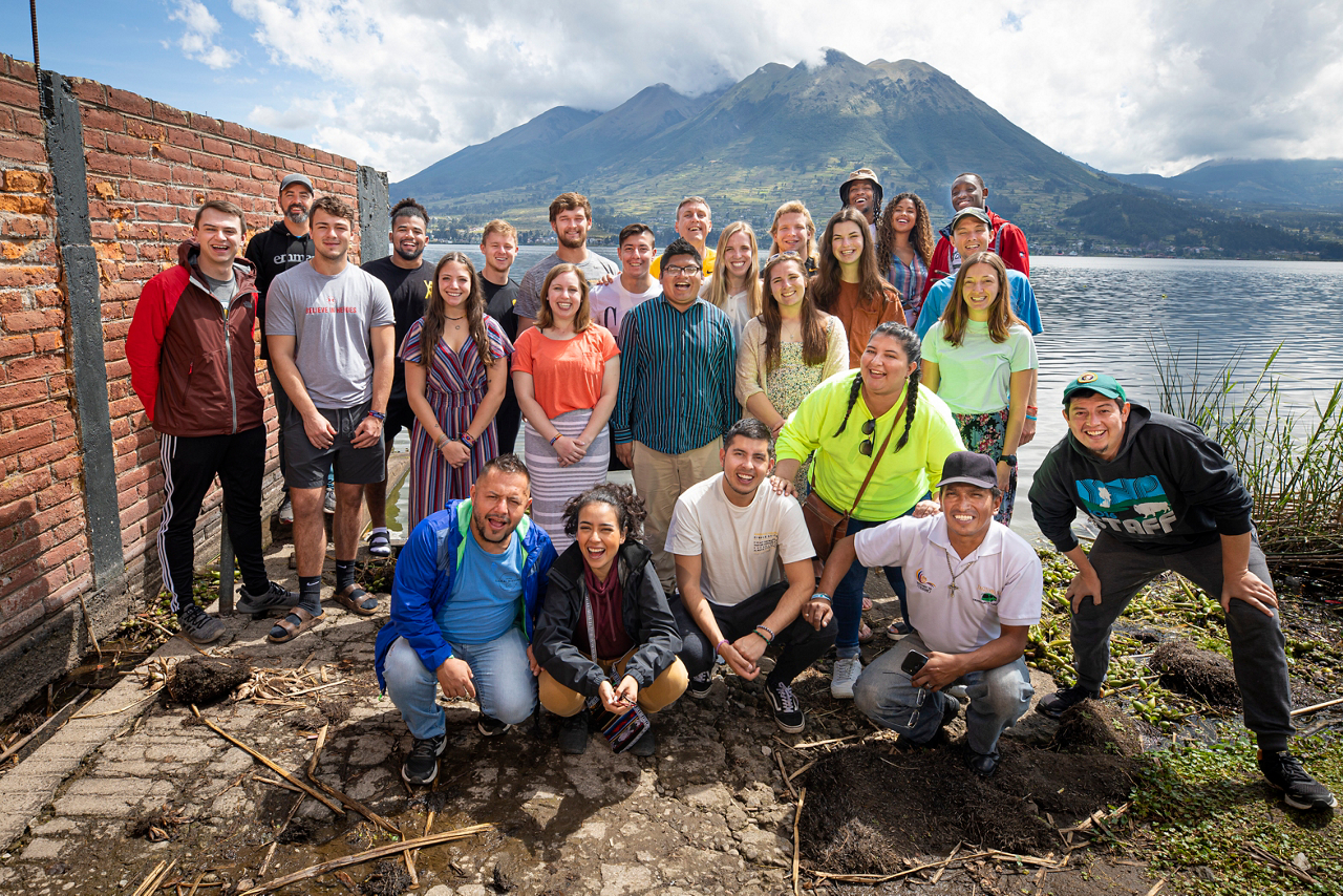 Athletes in Action students with interpreters and bus driver. The Imbabura volcano is in the background. 