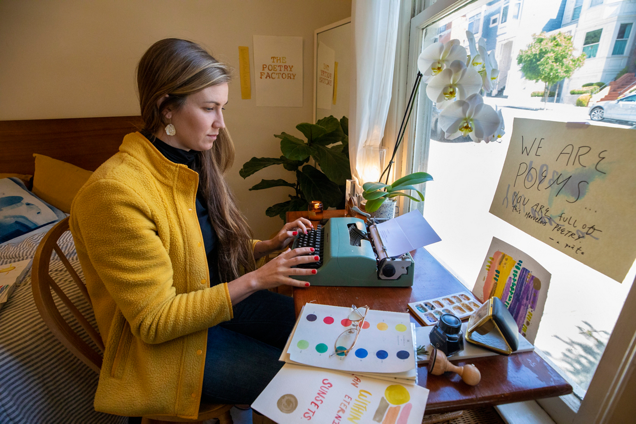 Hope types on her portable typewriter