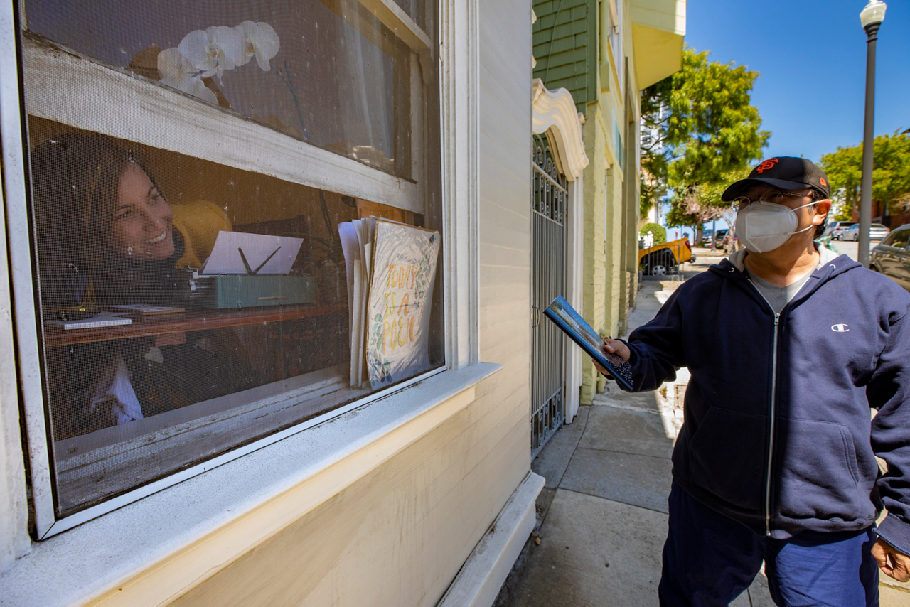 Hope engages with a neighbor through her bedroom window